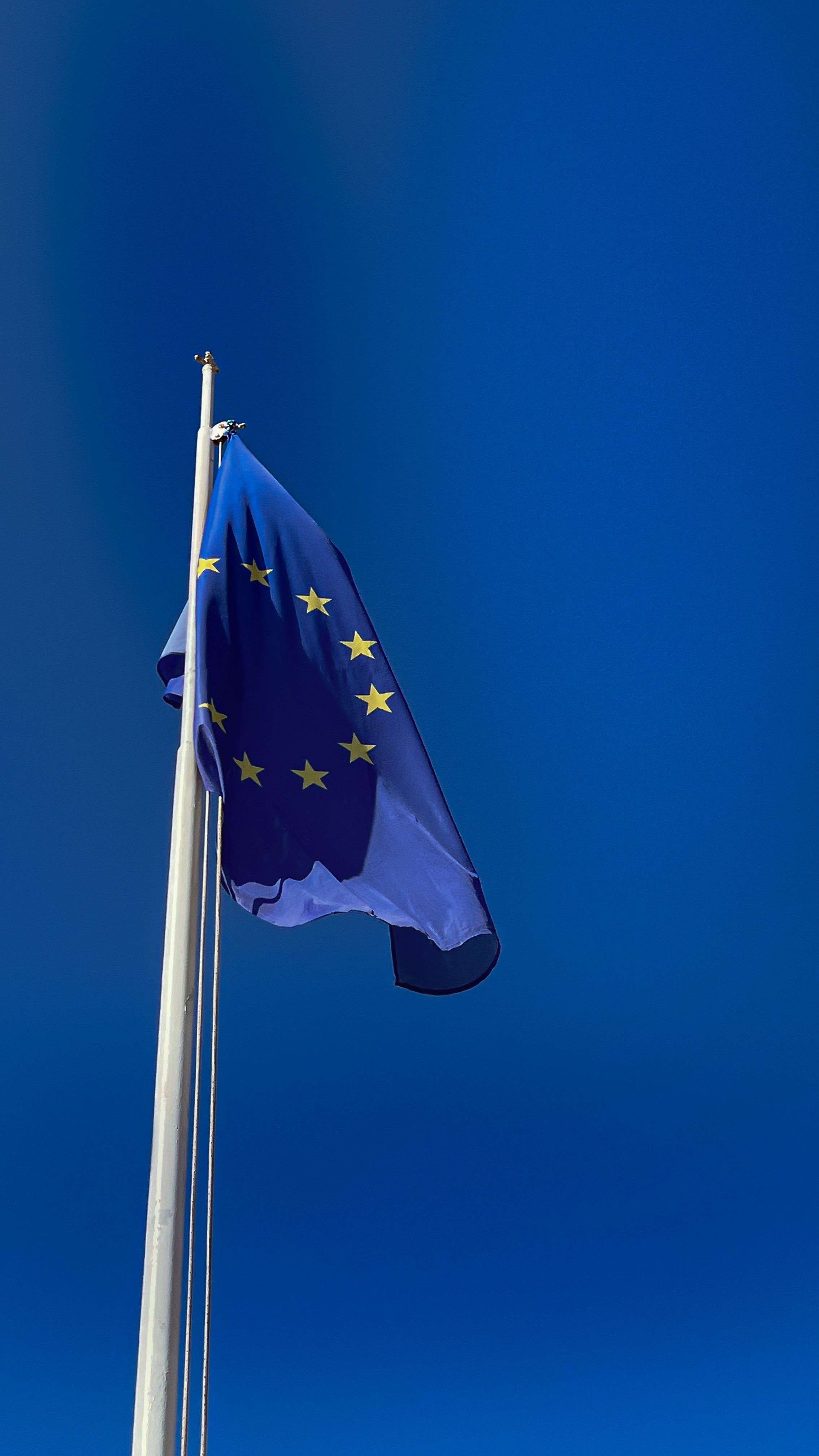 eu-flag-waving-in-a-clear-blue-sky-symbolizing-unity-and-peace-across-member-cou - viktorya-sergeeva-🫂 (pexels)