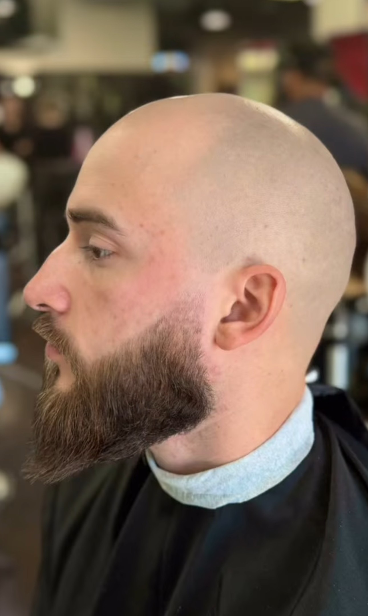 Bald look paired with a full beard and fade, crafted to perfection by Courtney Palmore.