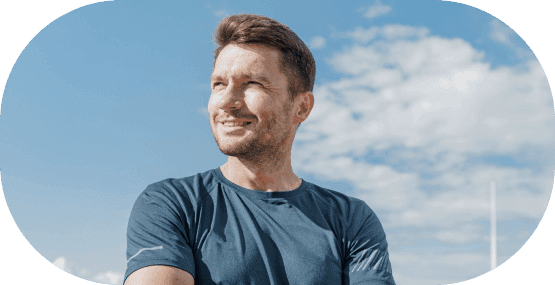 A man smiling happily after his exercise routine
