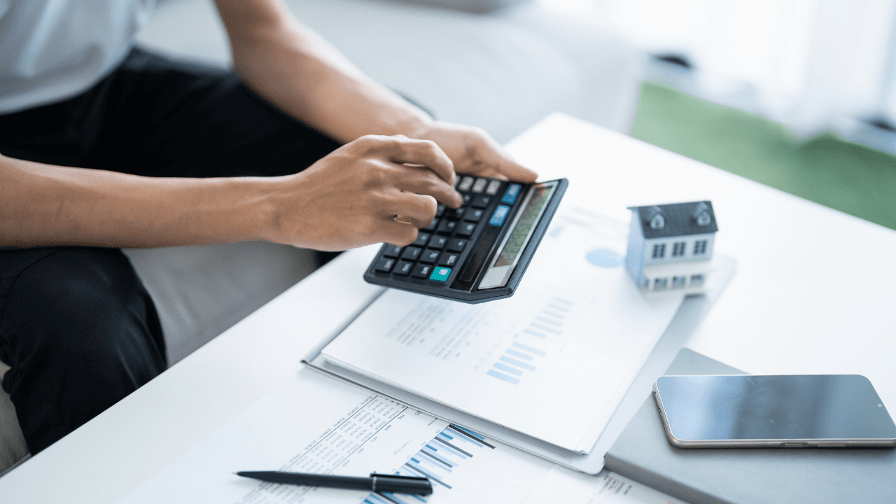 hand holding calculator to track prices online