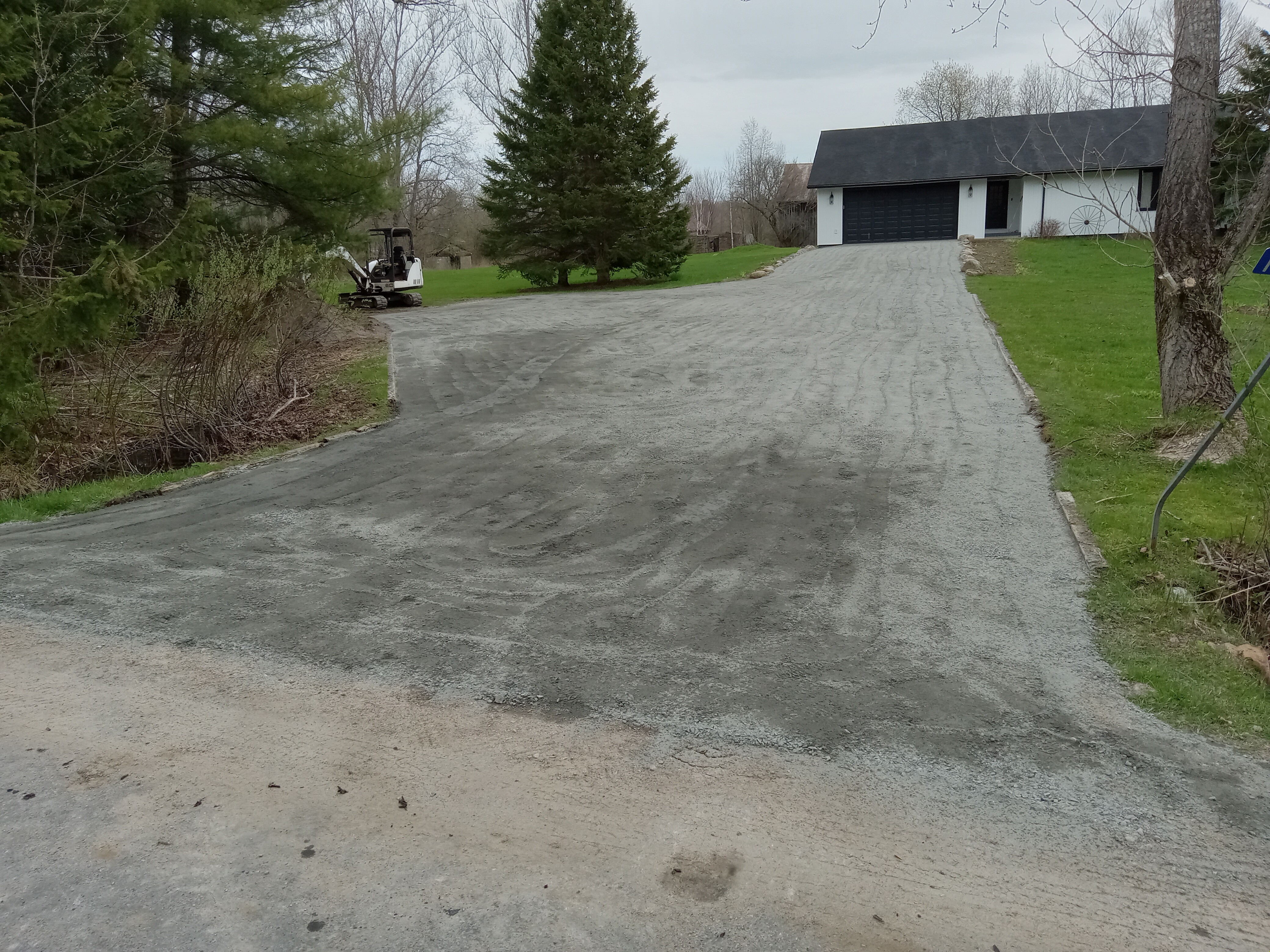 Completed gravel driveway graded to direct surface water away.