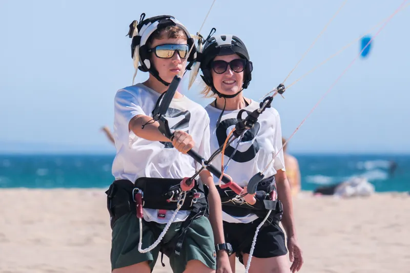 Kitesurf-Schüler lernen am Strand bei Explora Watersports Tarifa unter Anleitung eines Instruktors.
