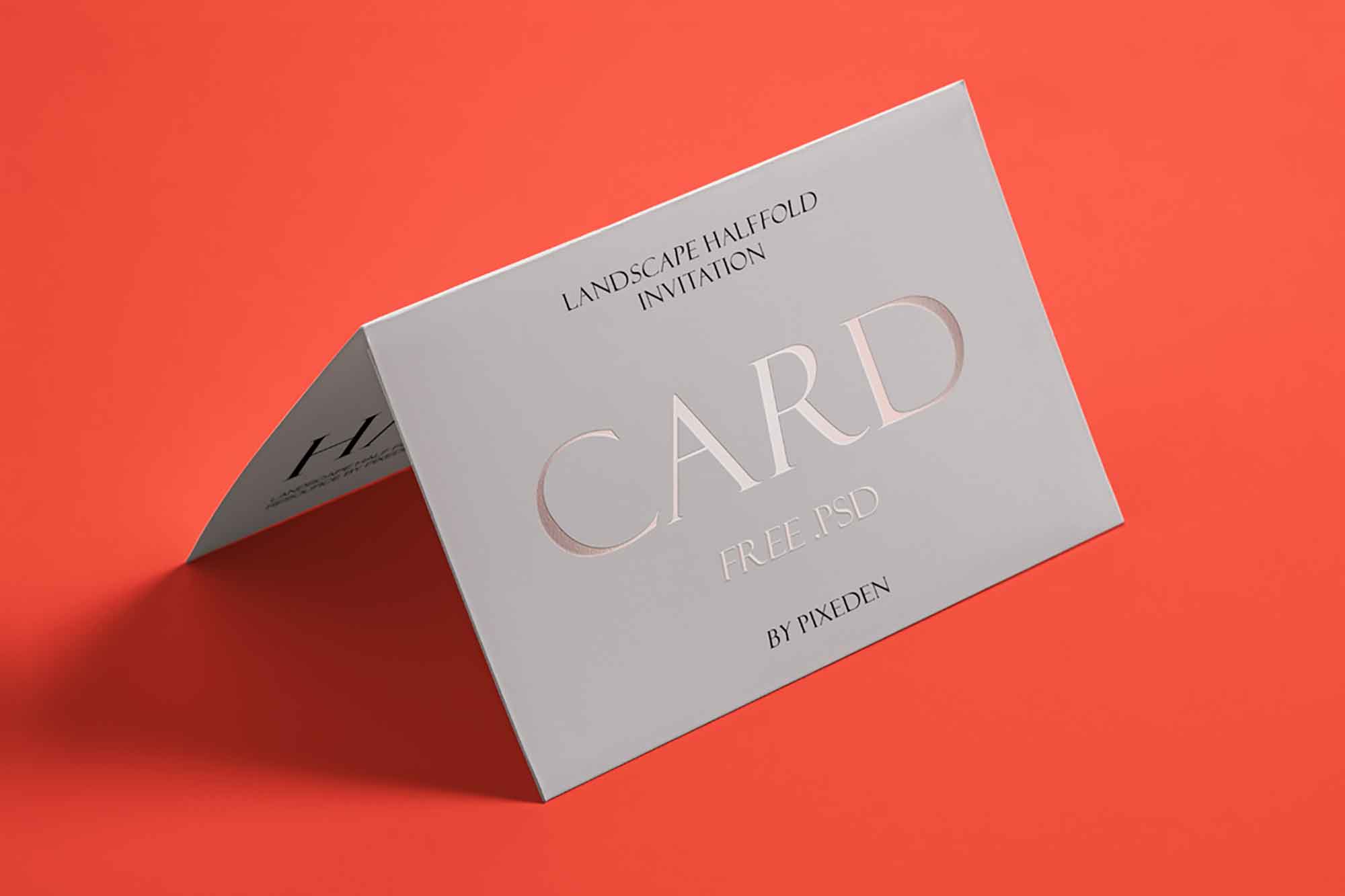 Landscape halffold invitation card mockup by Pixeden with rose gold embossed text.