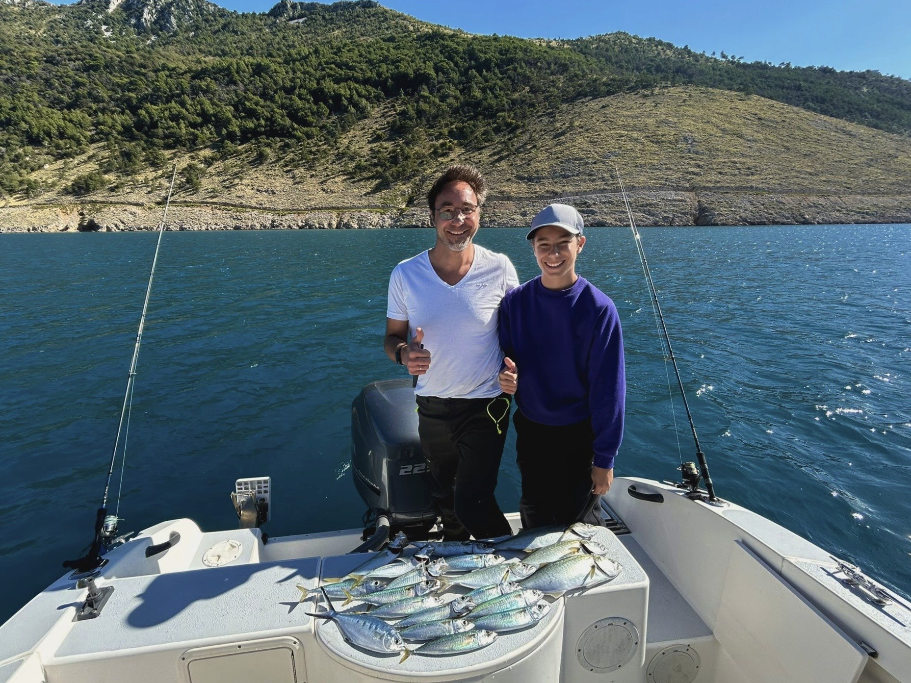 Dad and son fishing in Plomin Luka