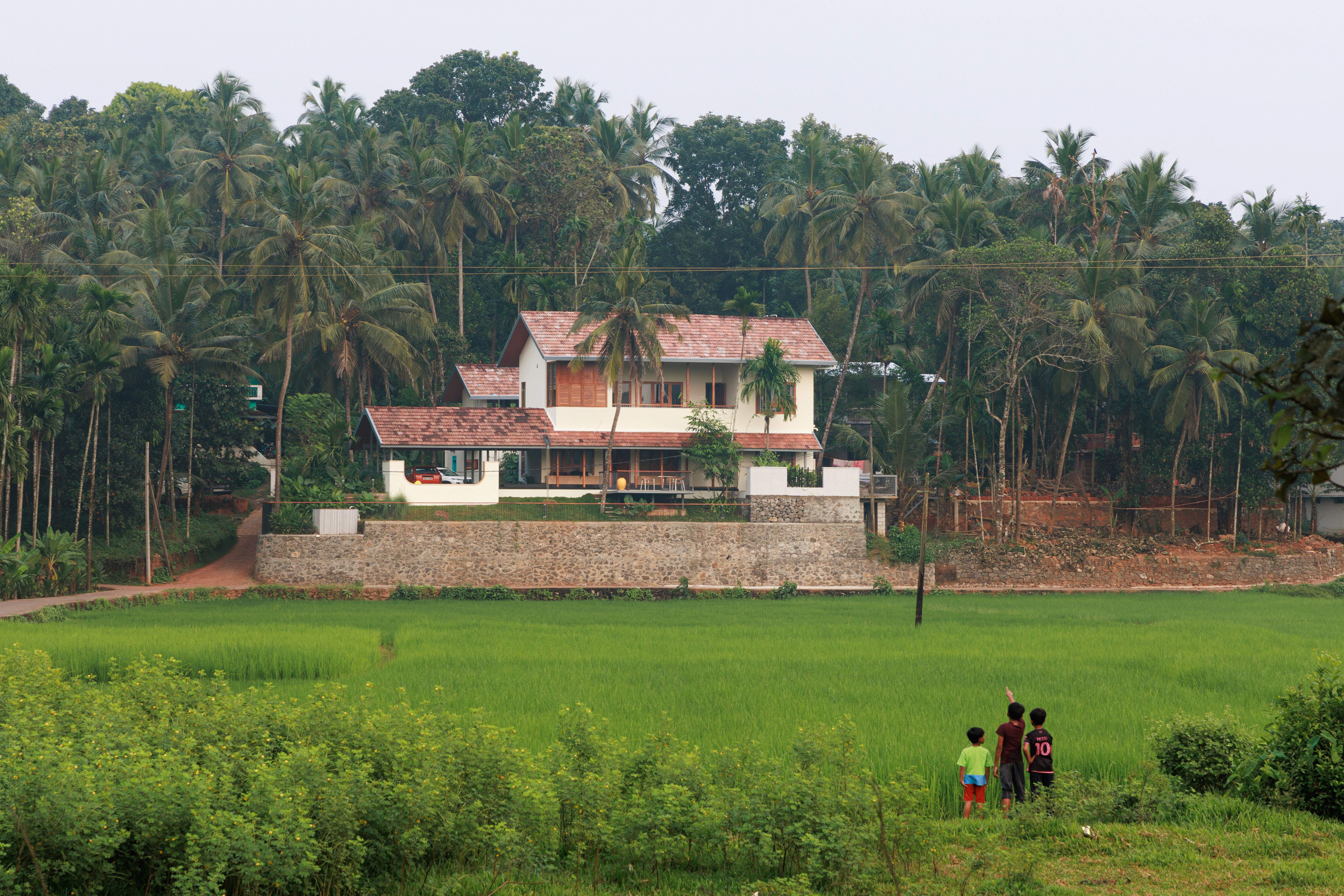 Luxury coastal residence with open-air living space and ocean views at sunset.