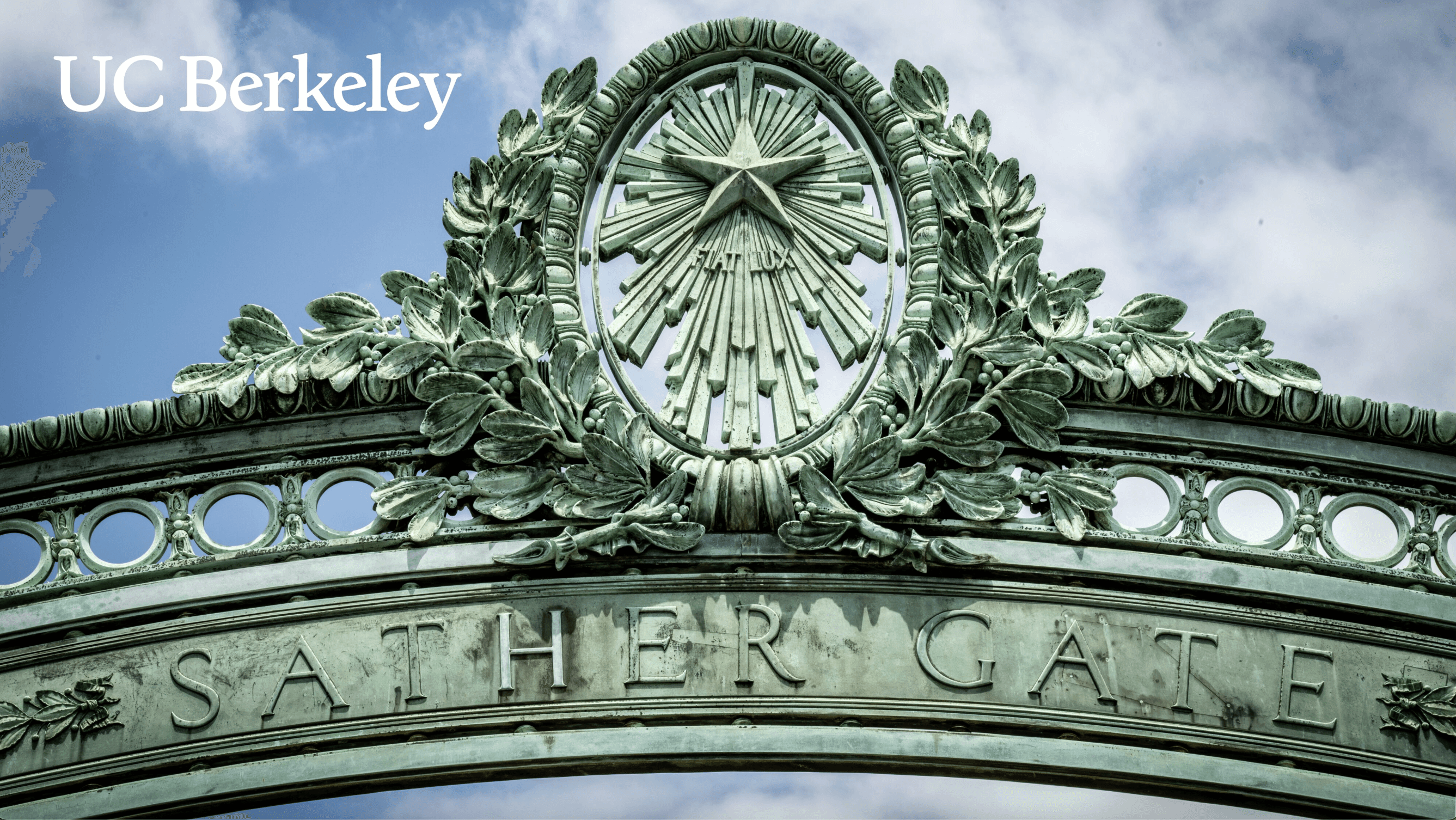 Modern red brick apartment or office building viewed from below against a blue sky, showcasing its geometric architecture with evenly spaced windows and balconies.