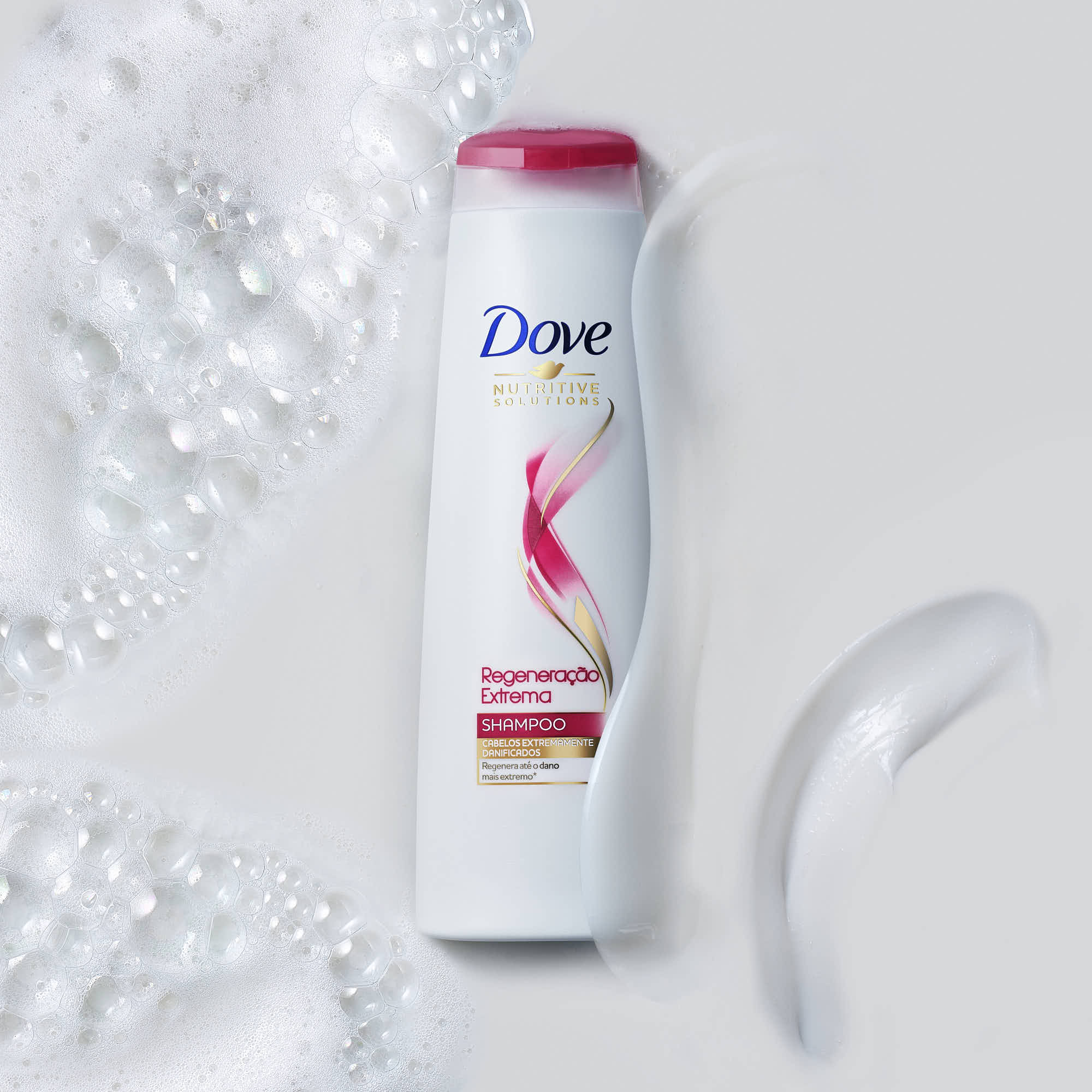 A bottle of shampoo with a red and white label against a light background, accompanied by a clear plastic cap.