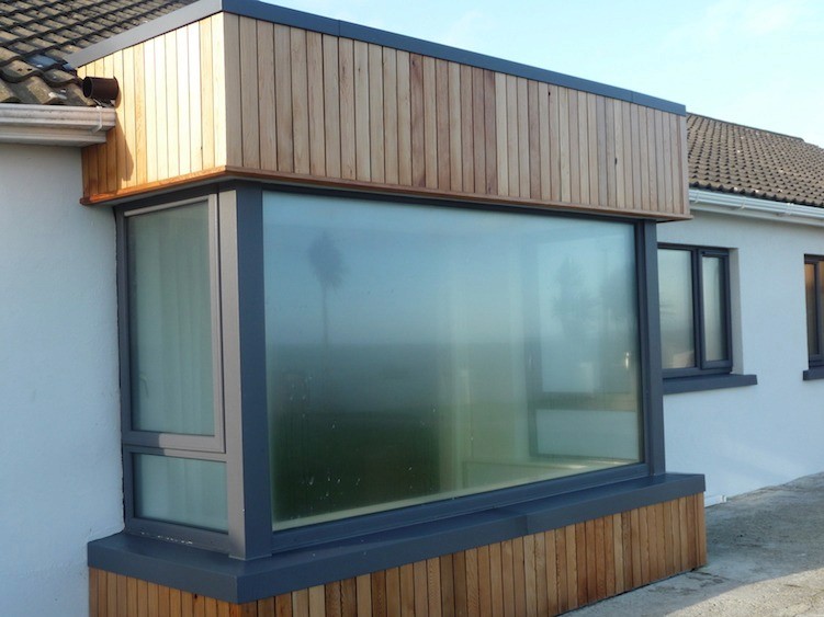 man in yellow shirt and blue denim jeans jumping on brown wooden railings under blue and