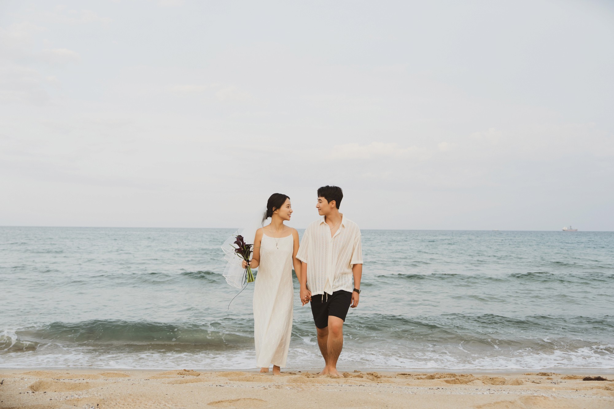 A woman smiling and wearing plants
