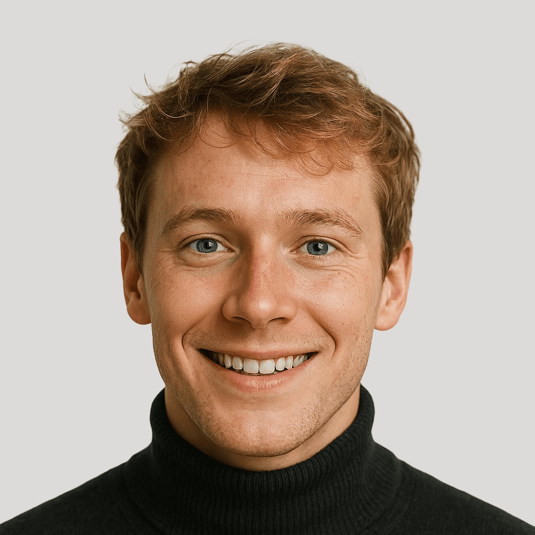Headshot of a young man with blue eyes and short blonde hair, smiling.