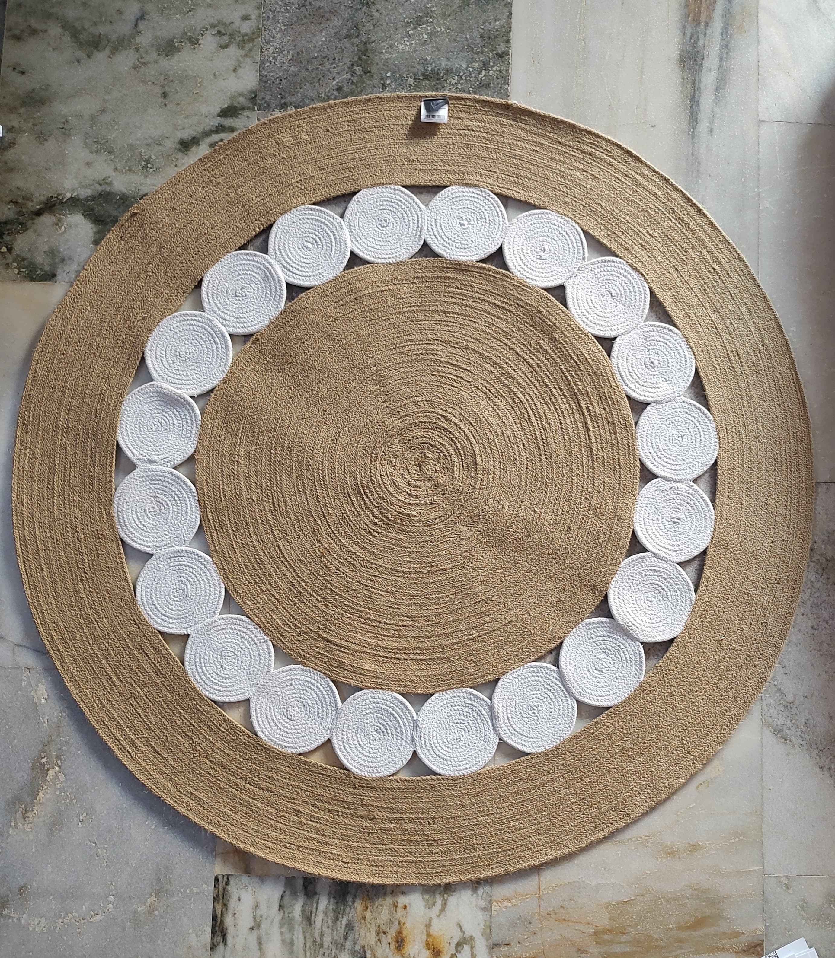 Handwoven round jute rug with white circular pattern