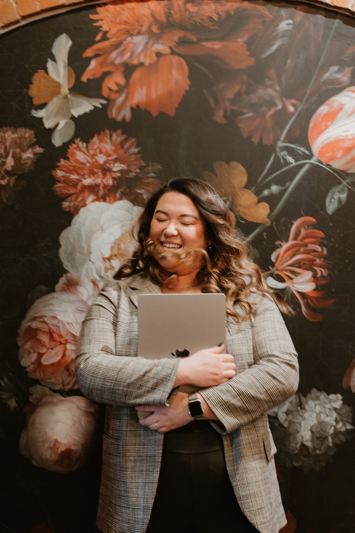 Lona holding laptop