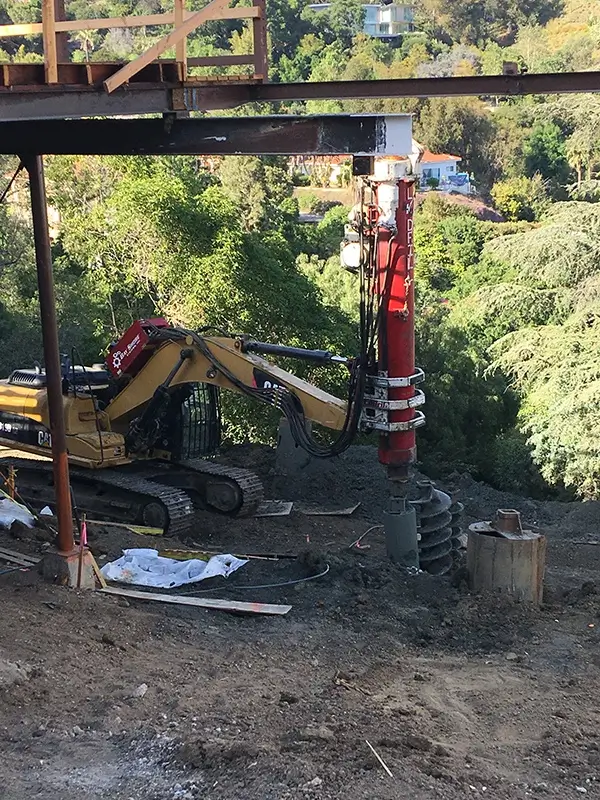 three people sitting in front of table laughing together