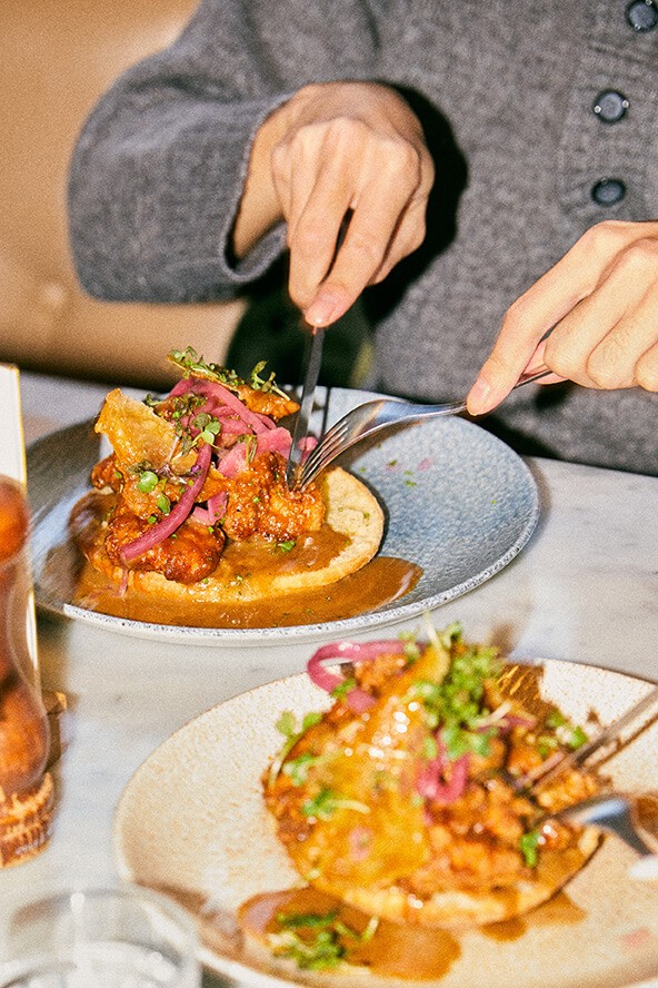 Person eating a chicken meal