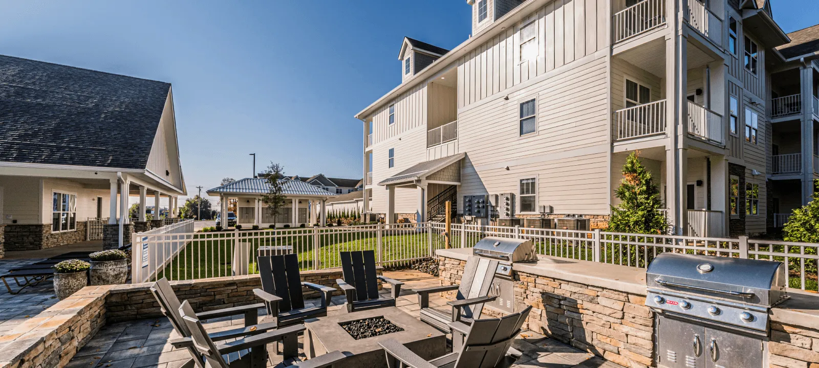 Outdoor BBQ and firepit area with grills and seating at The Reserve at Cool Springs, Elizabethtown, KY