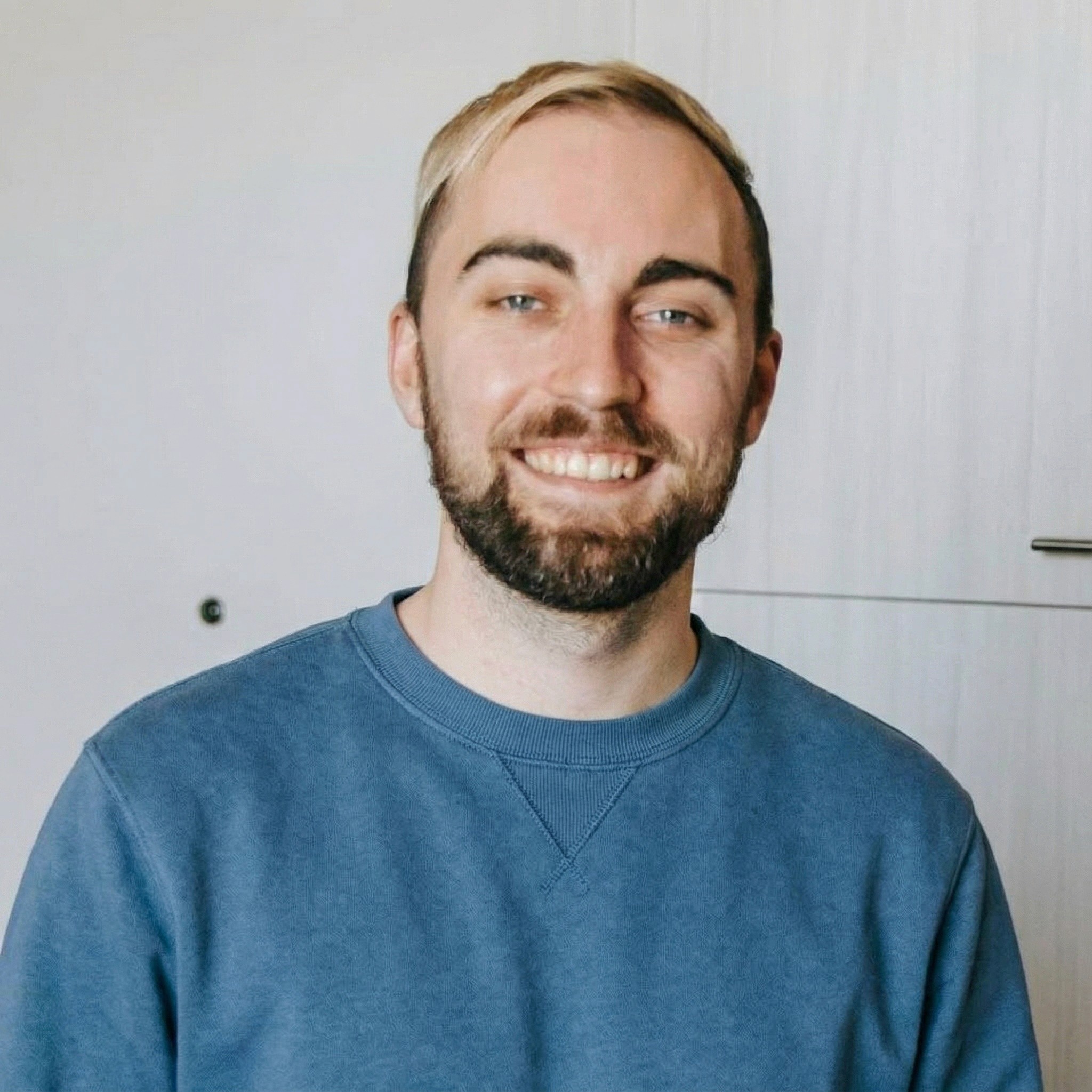 man in white crew neck shirt wearing black framed eyeglasses