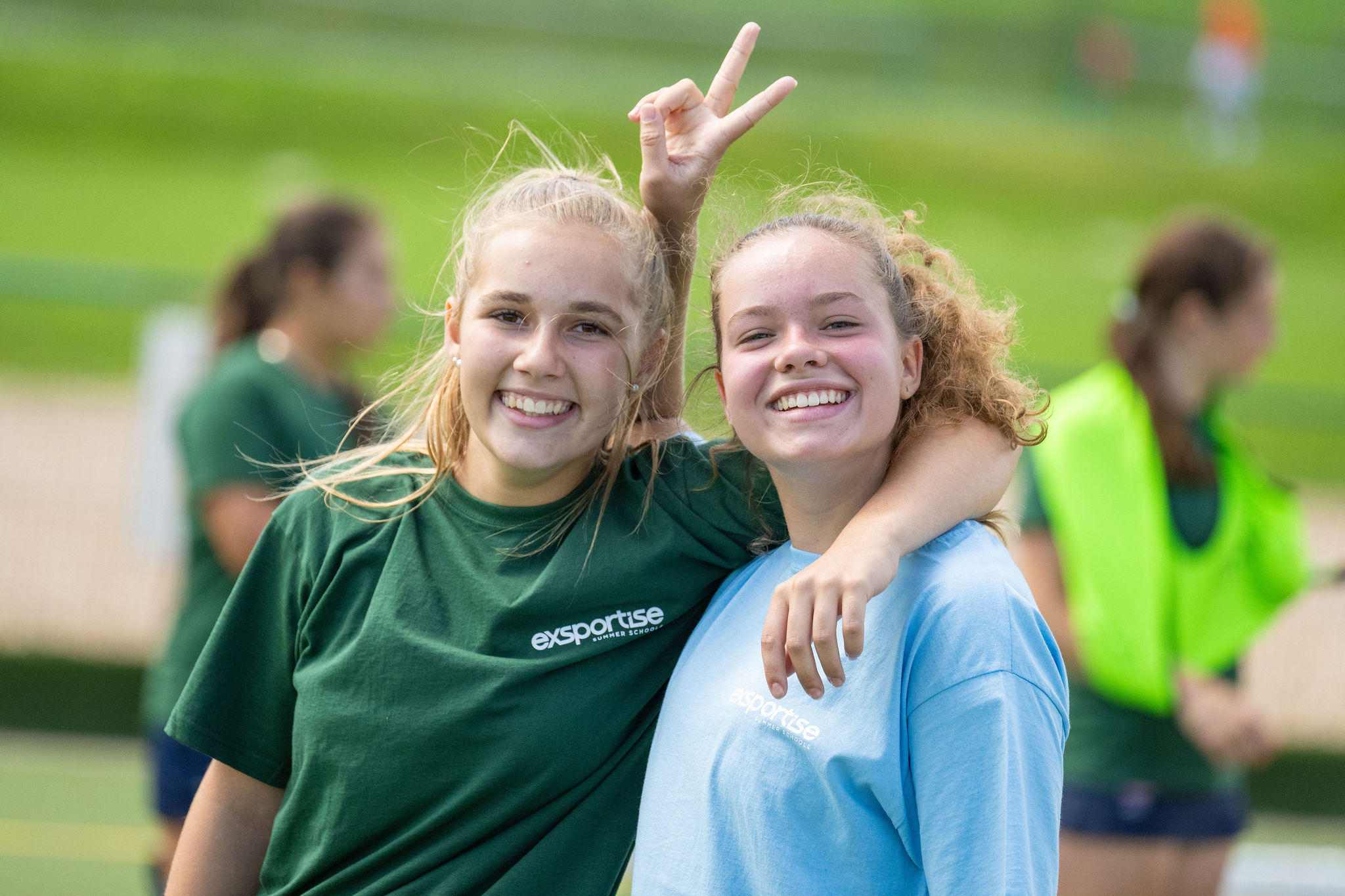 Two young female students smiling together.