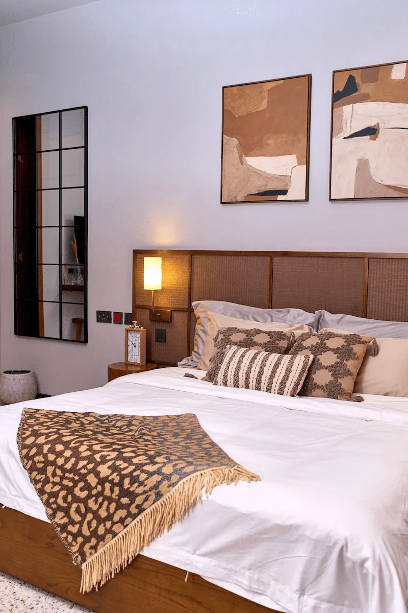 close shot of bed with cushions and throw