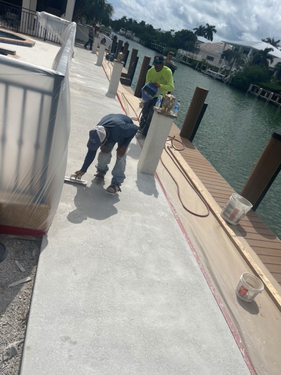 Modern bathroom featuring a walk-in shower, wooden vanity, round mirror, and elegant marble tiles.