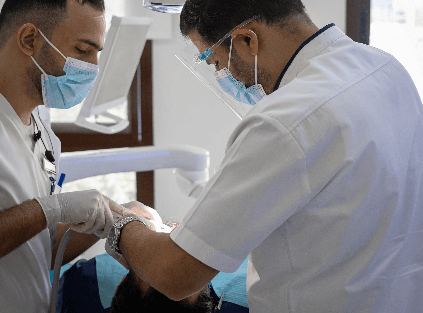 Doctor performing a Hollywood Smile procedure with an assistant at Bella Medical Center.