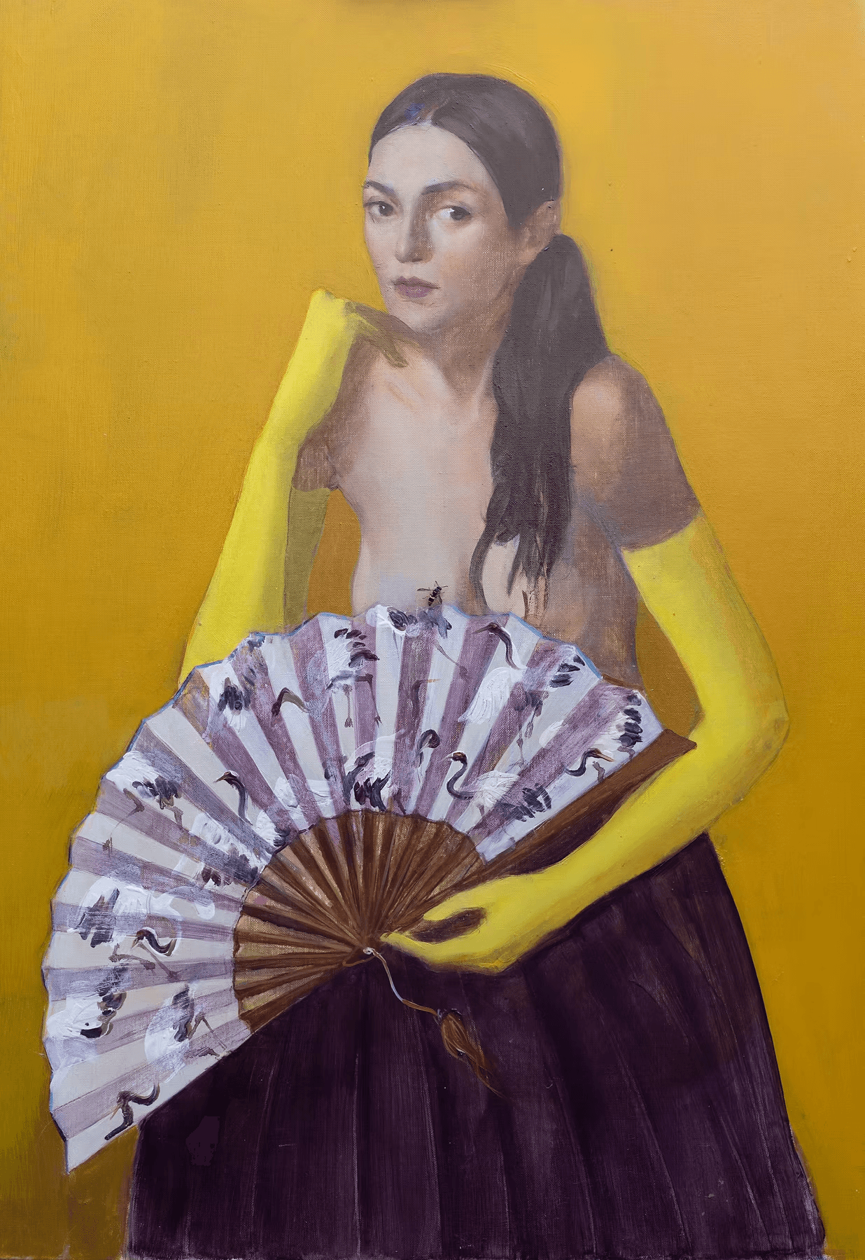 A woman wearing long yellow gloves and a dark skirt holds an ornate, patterned fan against a mustard yellow background, adding an artistic and classical touch to the portrait.
