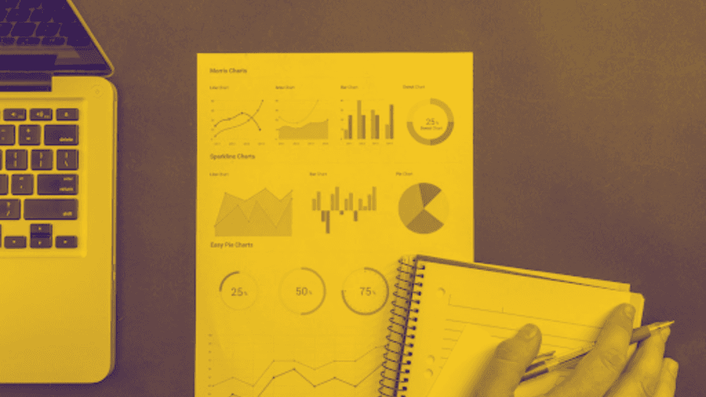 charts on a desk with yellow overlay