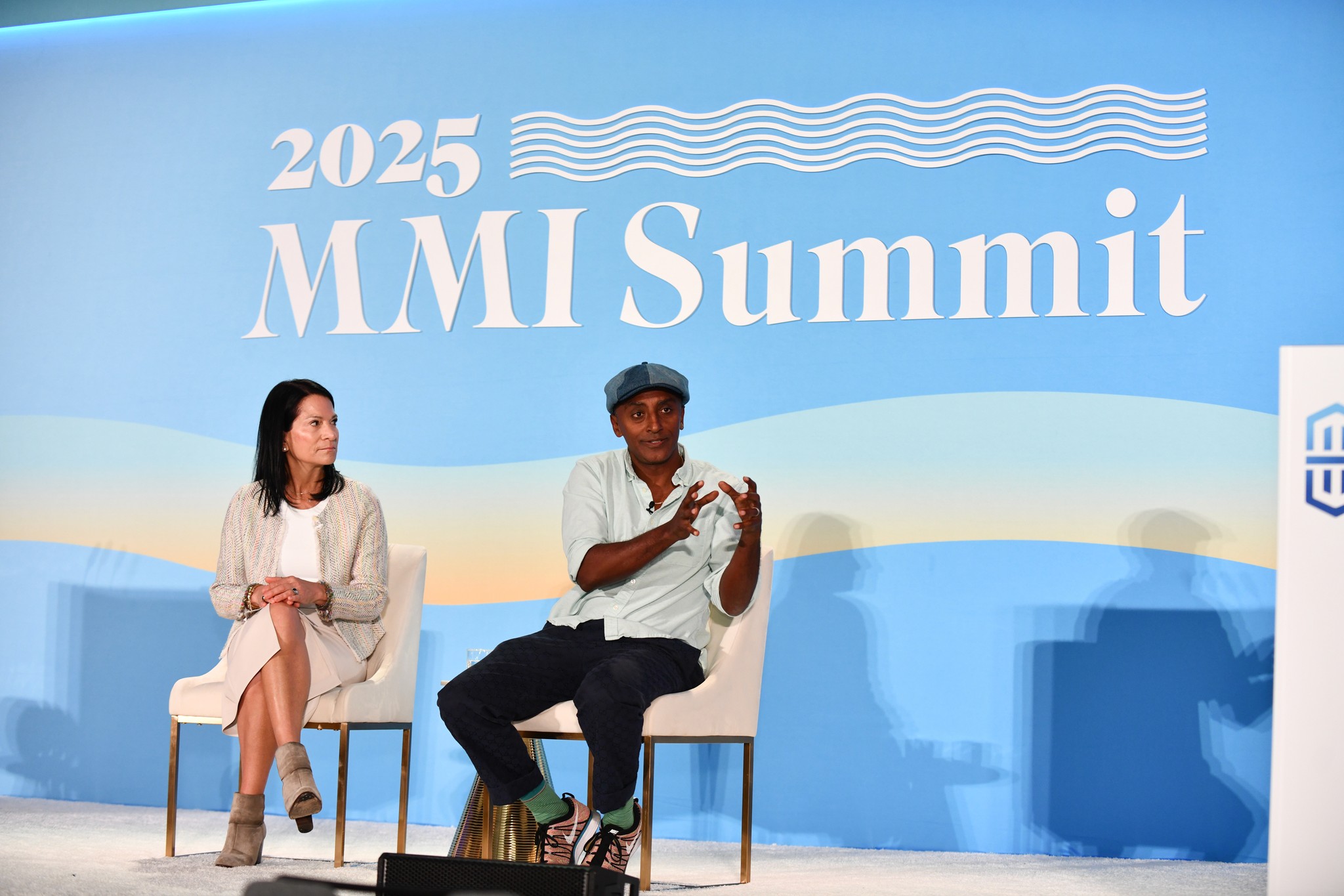 2025 MMI Summit stage medium view with two speakers sitting in chairs