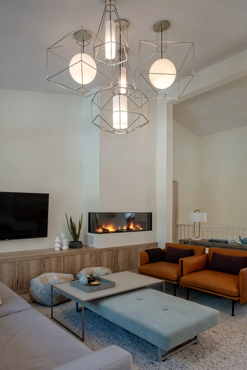 Image of Modern living room interior design with geometric chandelier, furniture, and layout design by KHD Homes.