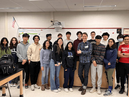 A dropper is releasing a drop of liquid into a dark glass bottle, with a soft green background.