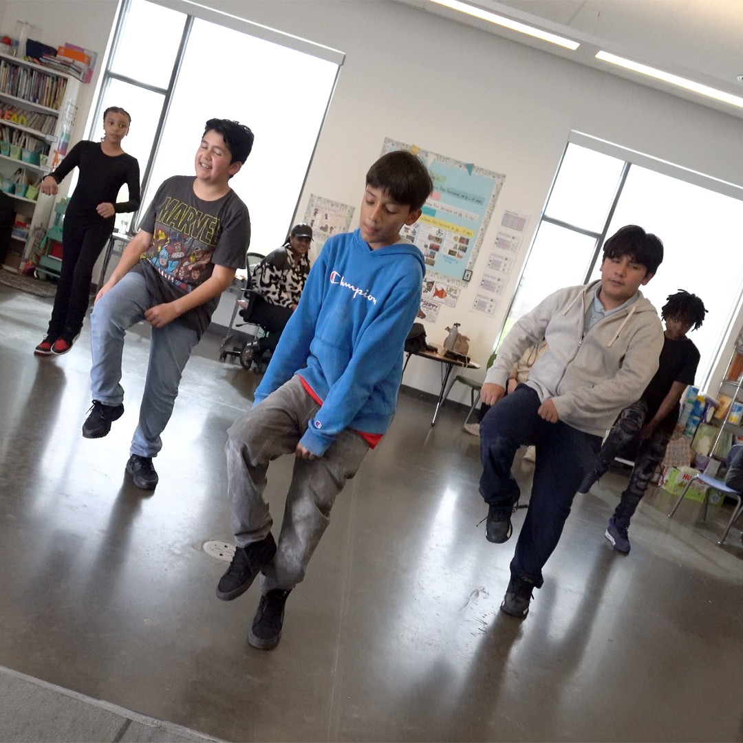 Students learning hip hop choreography in high-energy after school dance program