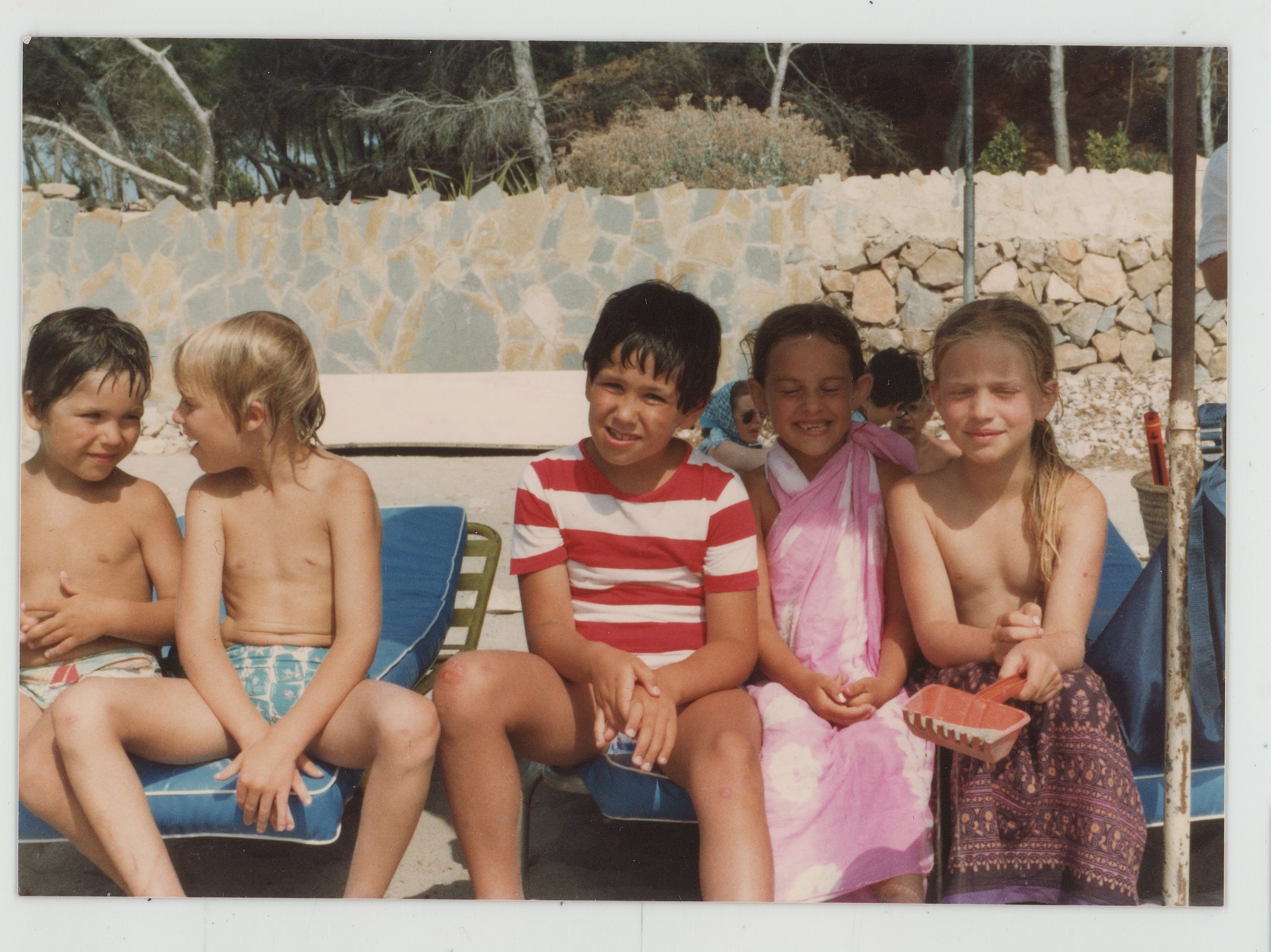 Vintage photo of the cousins as children sitting by a pool