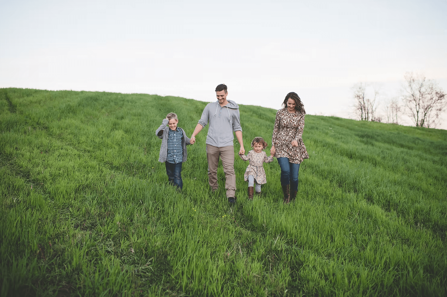 family on a grassy hill