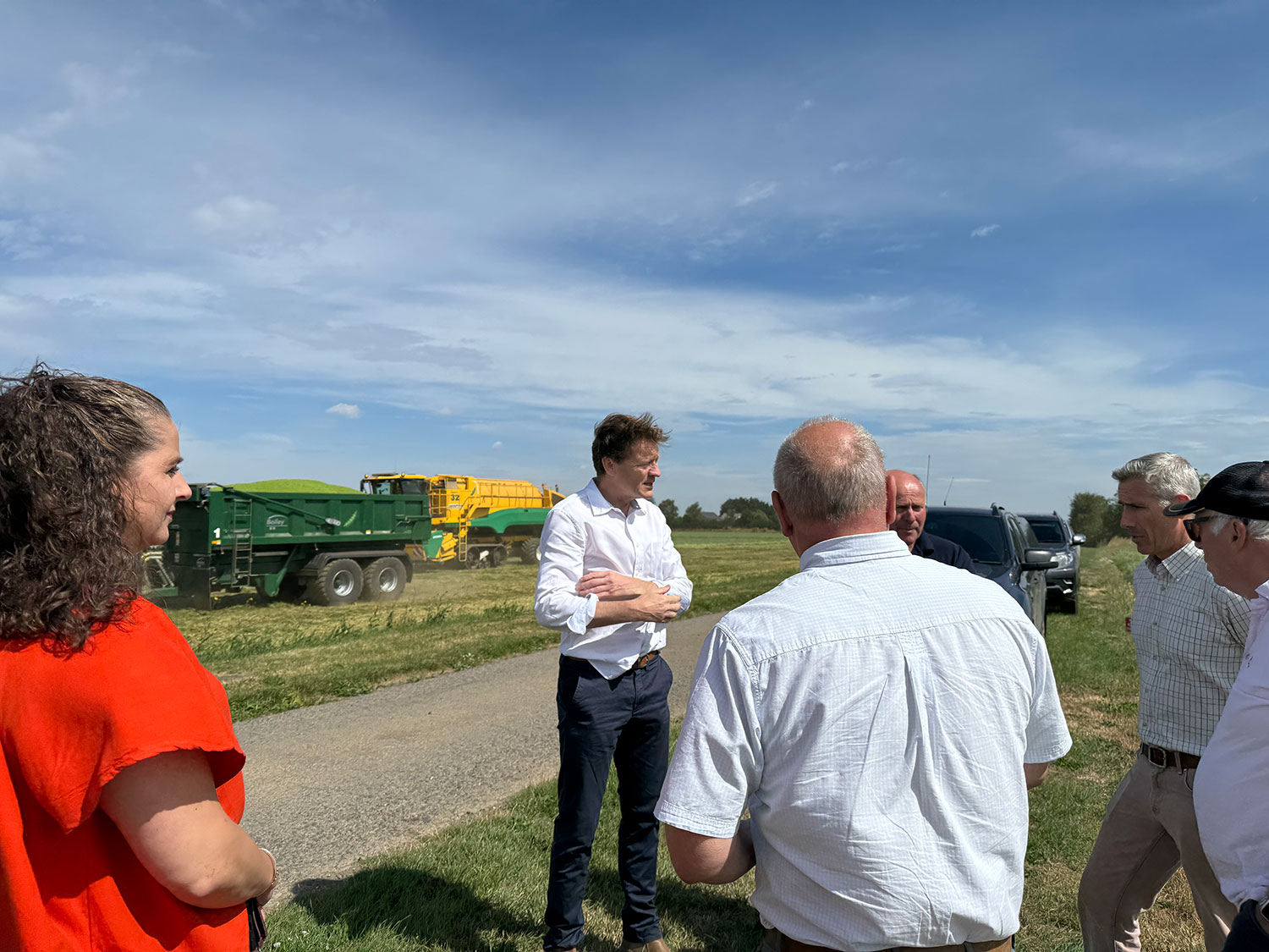 Richard Tice MP visiting during a harvest. He is on the edge of a field discussing challenges with a group of farmers