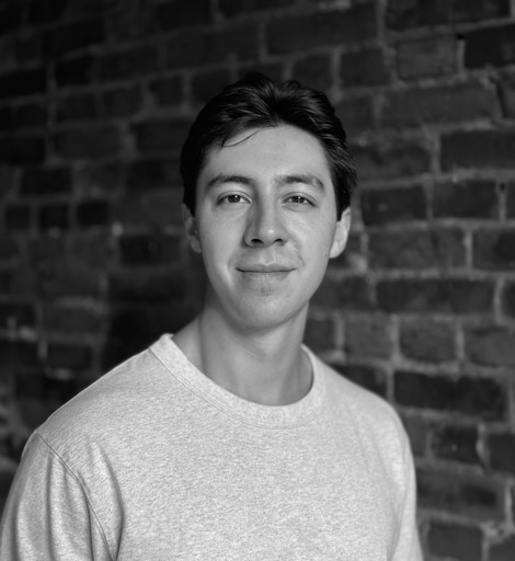 A black-and-white photo of myself standing in front of a brick wall