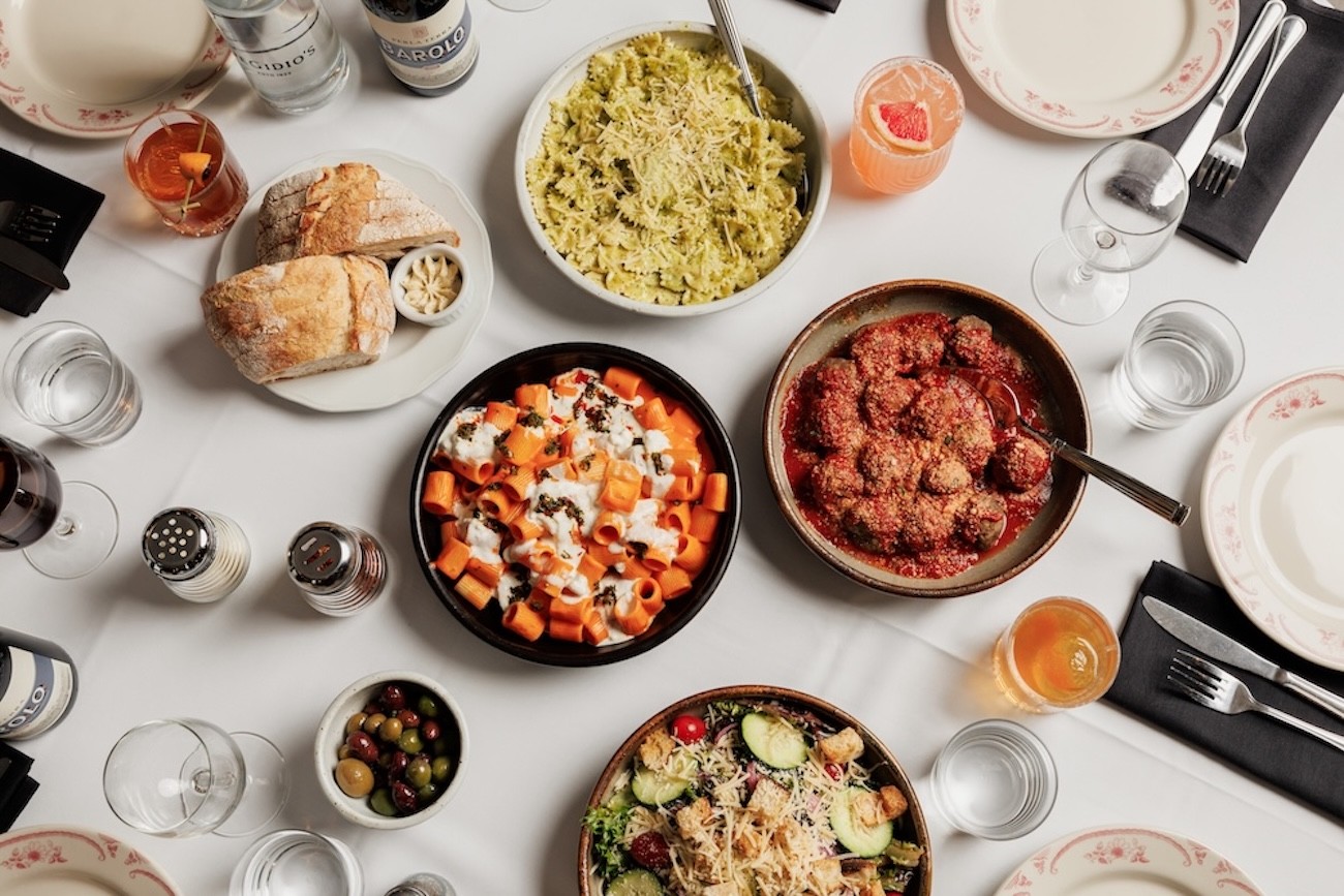 Chef plating a fried chicken sandwich