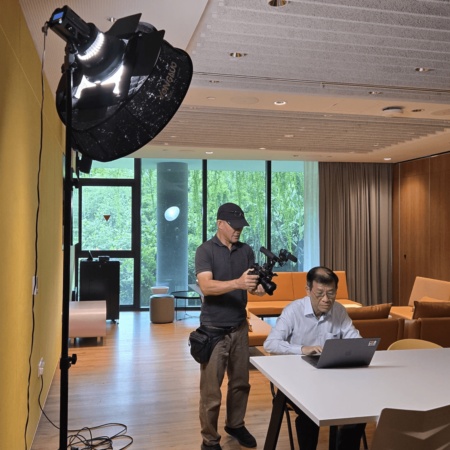 production behind the scenes filming man on laptop