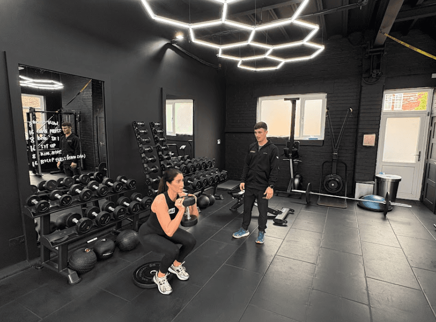Personal trianer in Wilmslow coaching a client on cross training exercise.