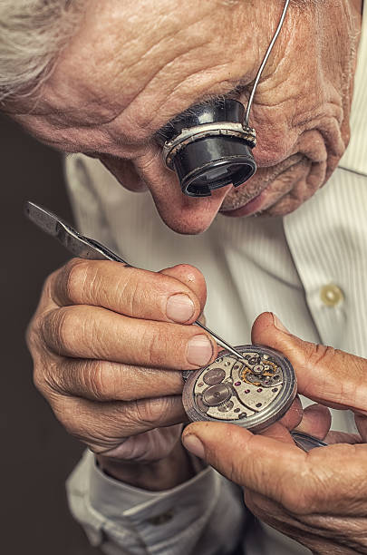 Old watchmaker servicing watch