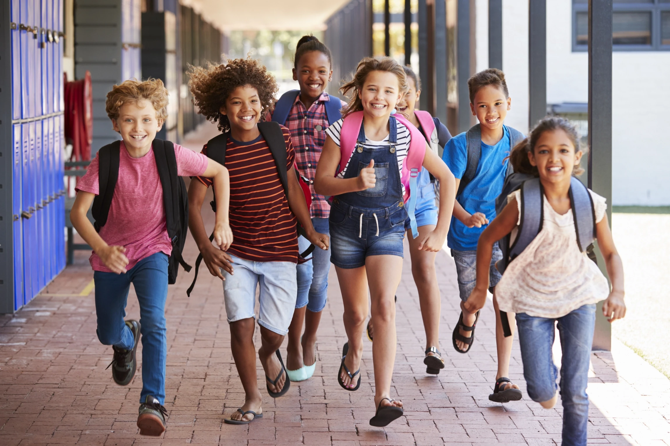 school kids running forward together