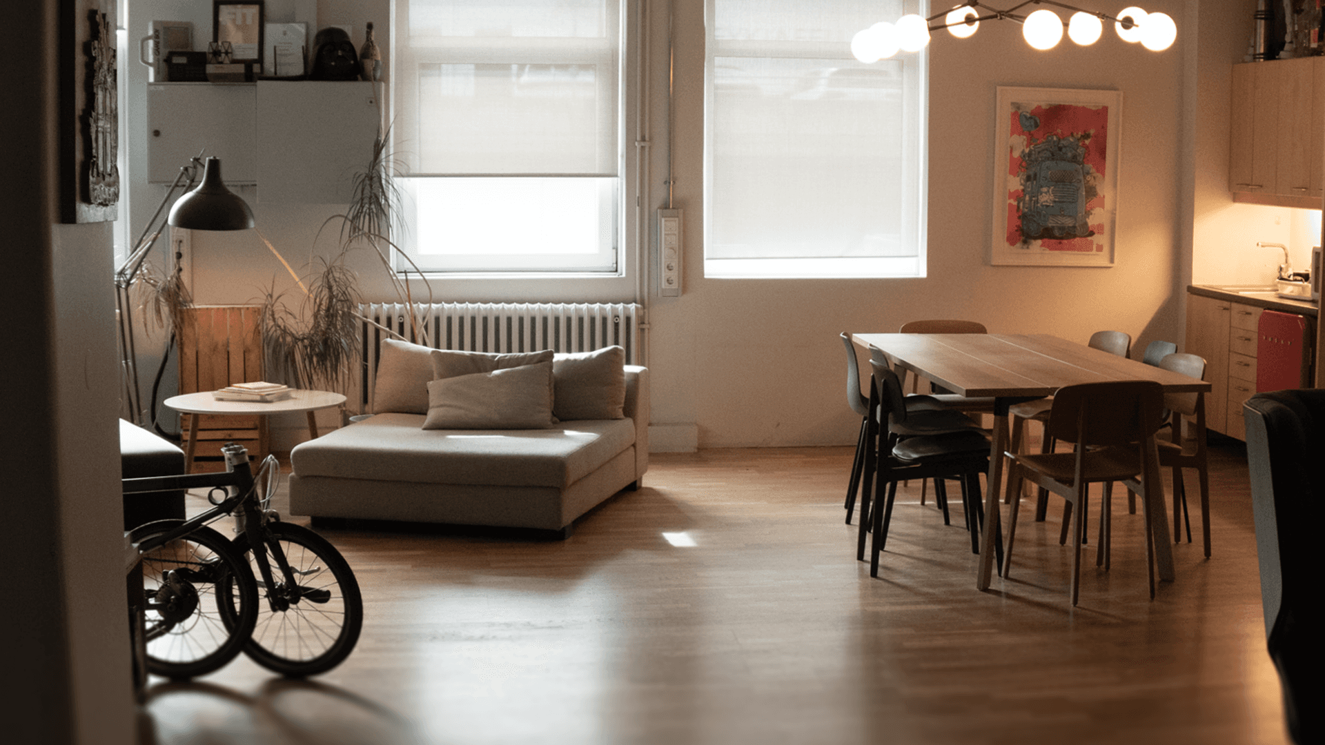 Black and white image of people working at a table with laptops, showing hands gesturing during discussion of digital content displayed on screens, with fabrica® logo in the corner.