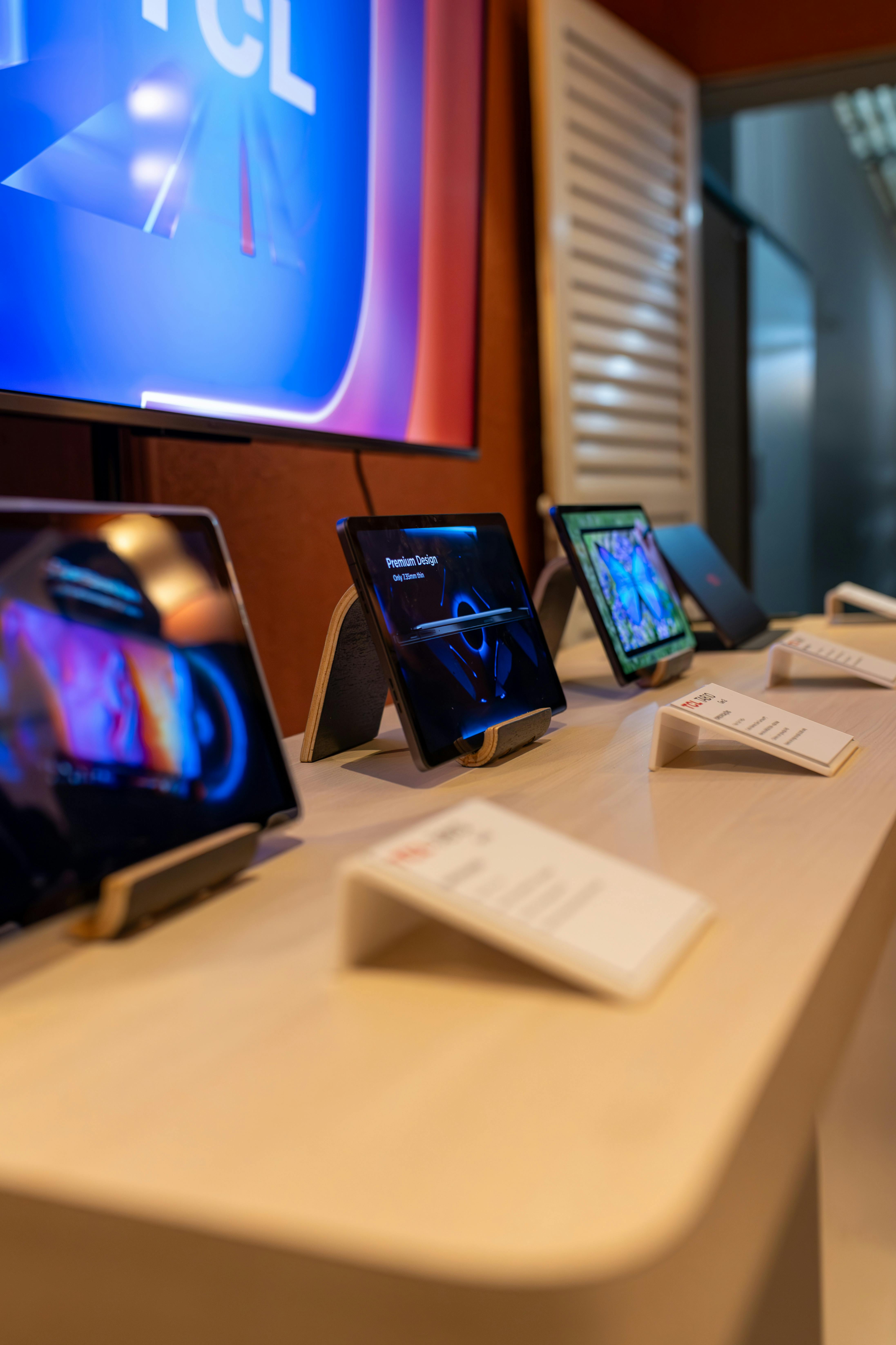 Tablet devices displayed on stands in an electronics store