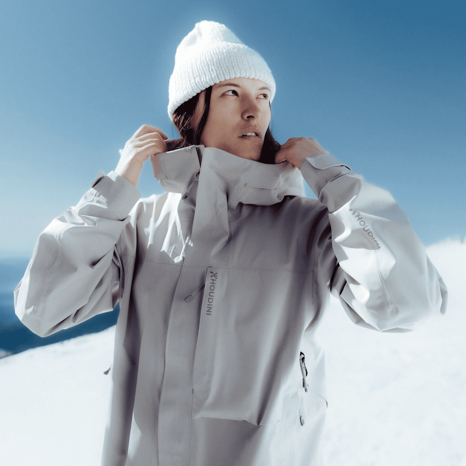 picture of a woman looking to the side in a snowy landscape.