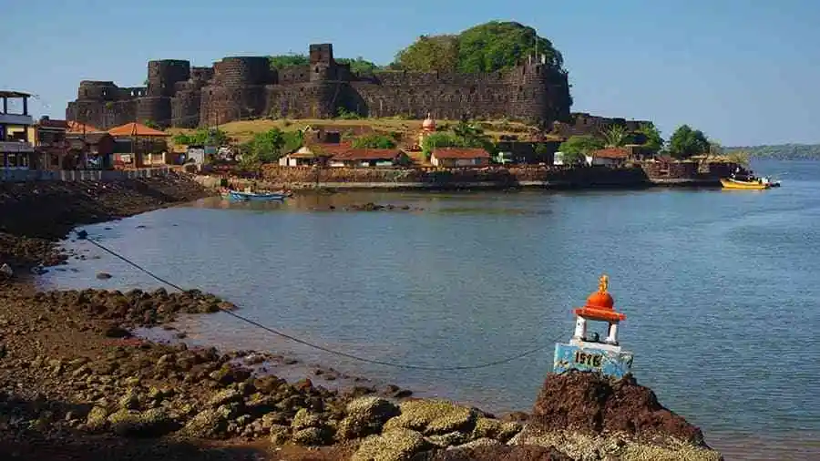 <img src="coastal-fort-goa.webp" alt="Aerial view of a historic coastal fort surrounded by turquoise blue sea, rocky shores, and a hidden sandy beach. The curved stone walls of the fort contrast with the natural textures of the sea and rugged landscape, capturing the scenic beauty and architectural charm of the Konkan coastline. Ideal for travel, history, and heritage tourism visuals.">