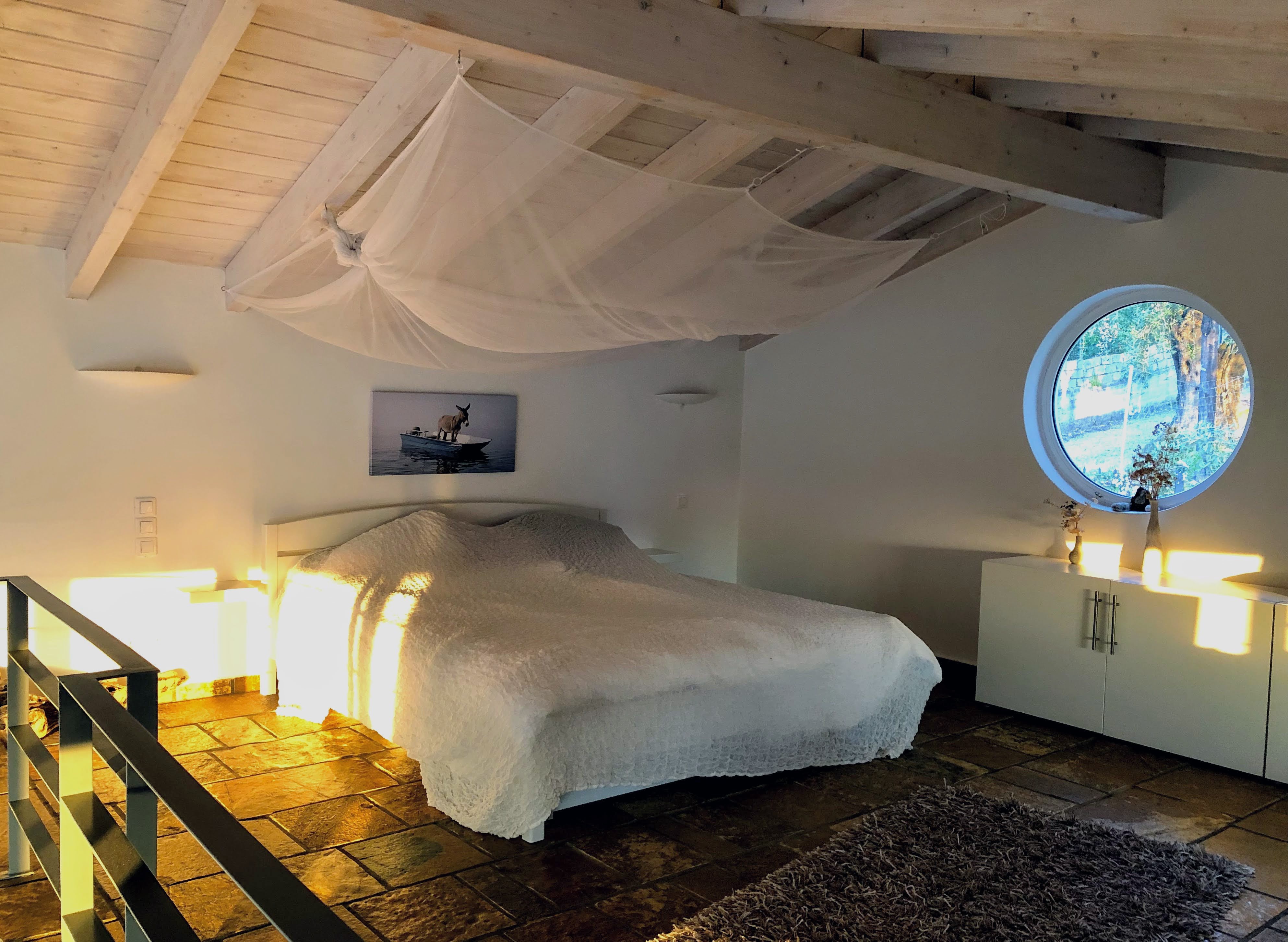 Bedroom at Villa Kalivi with sloped ceiling and natural light