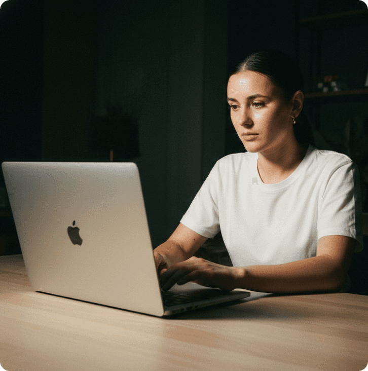 Dubai free zone company - Two men smiling, reviewing documents together at a table. One wears a brown jacket.