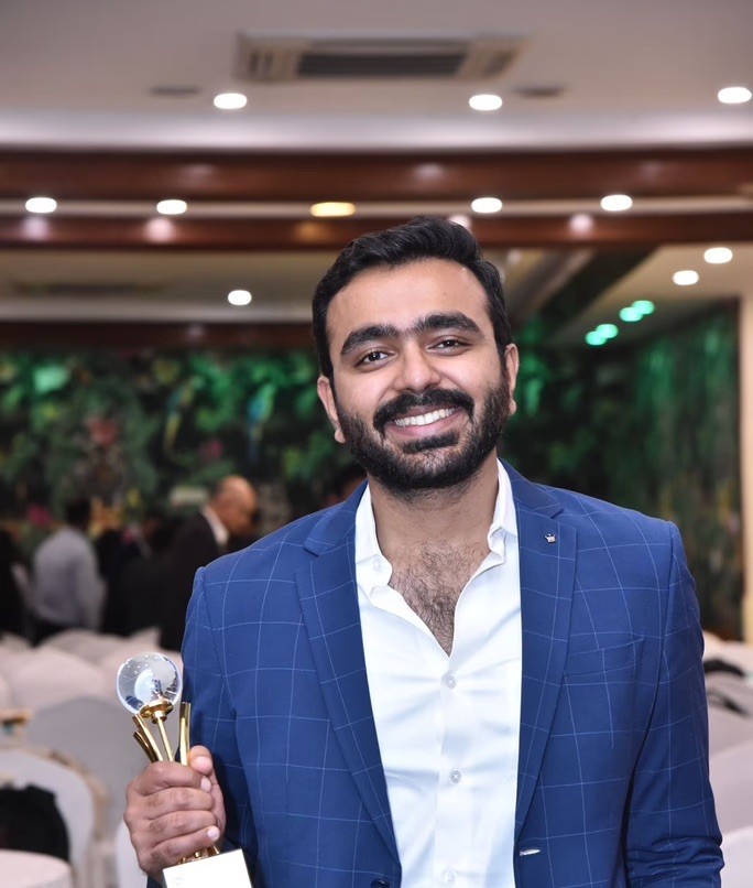 a woman in a black suit and sunglasses