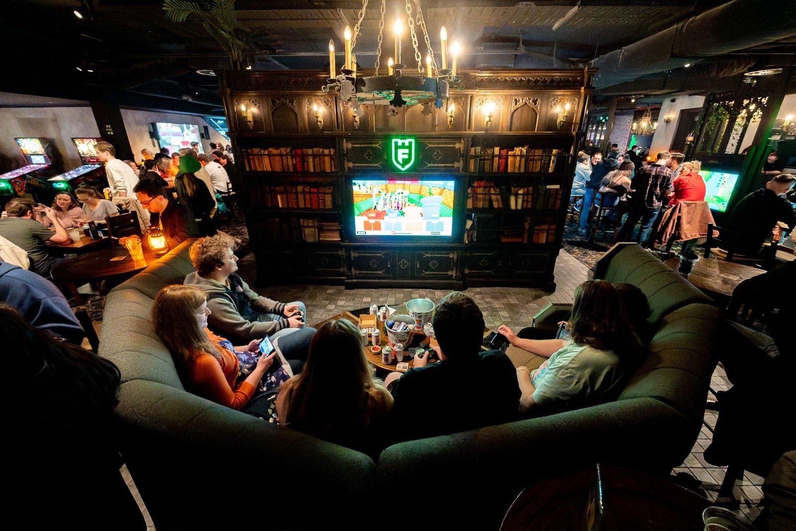 A group of people holding controllers at the console booth at Fortress
