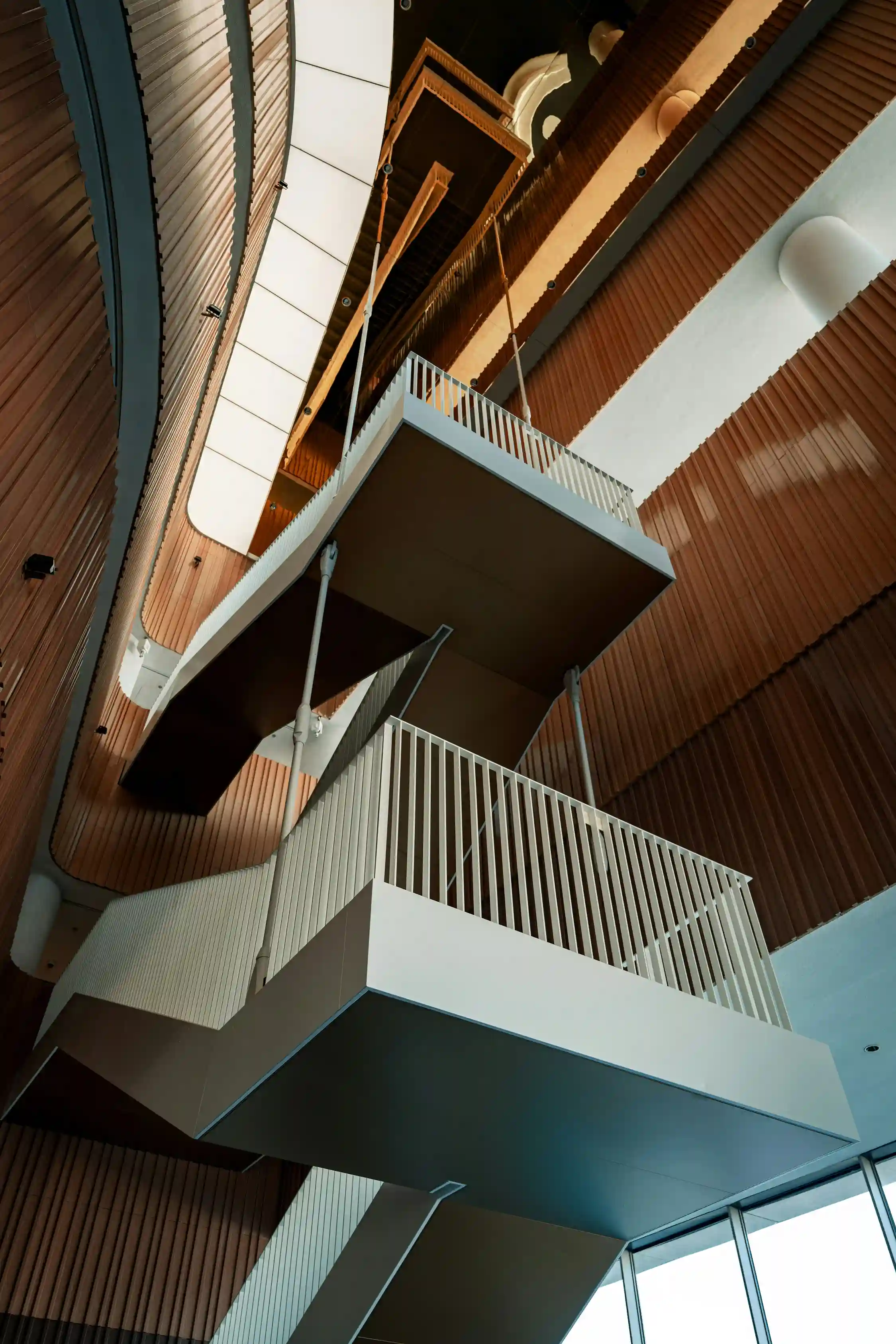 An architectural interior features suspended staircases.