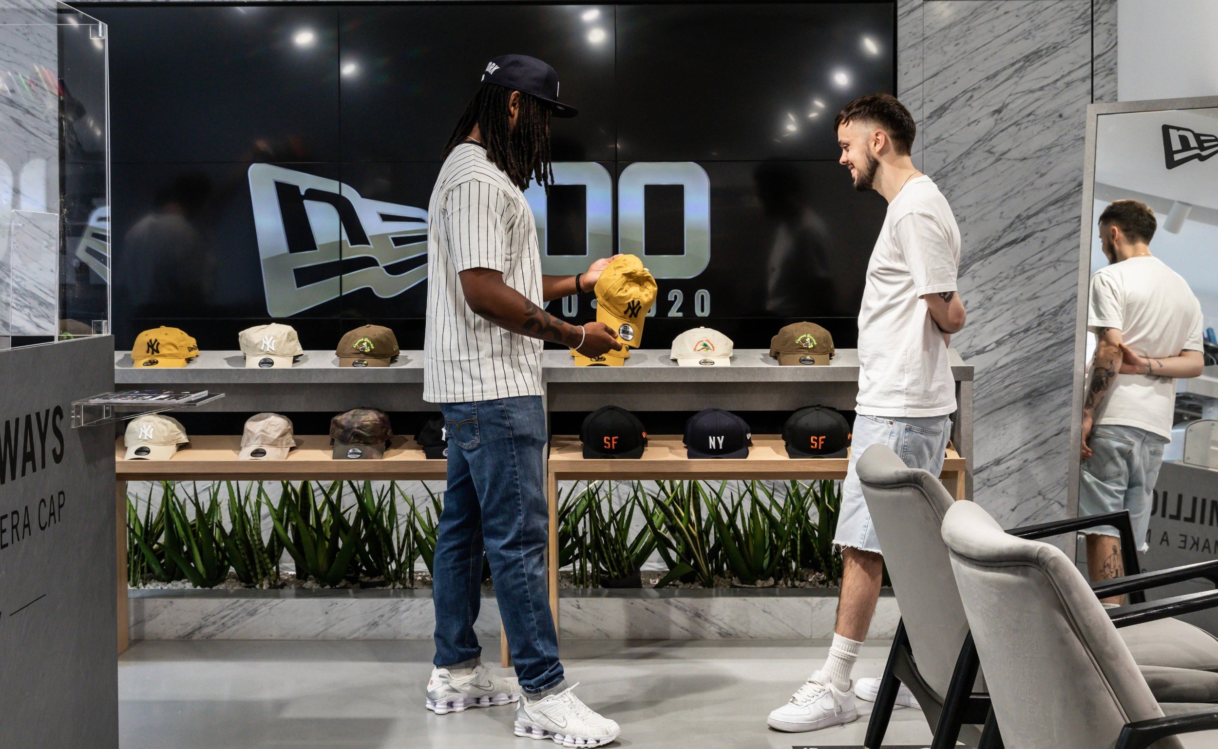 Contemporary retail interior design featuring elevated product displays, bold colour accents, and visual merchandising for a modern store environment.