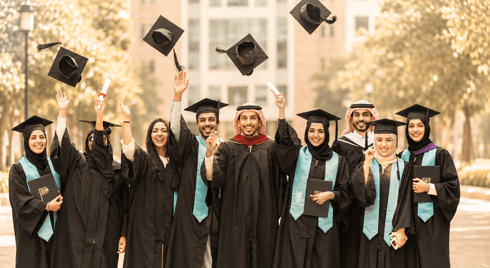 people in black academic dress standing on green grass field during daytime